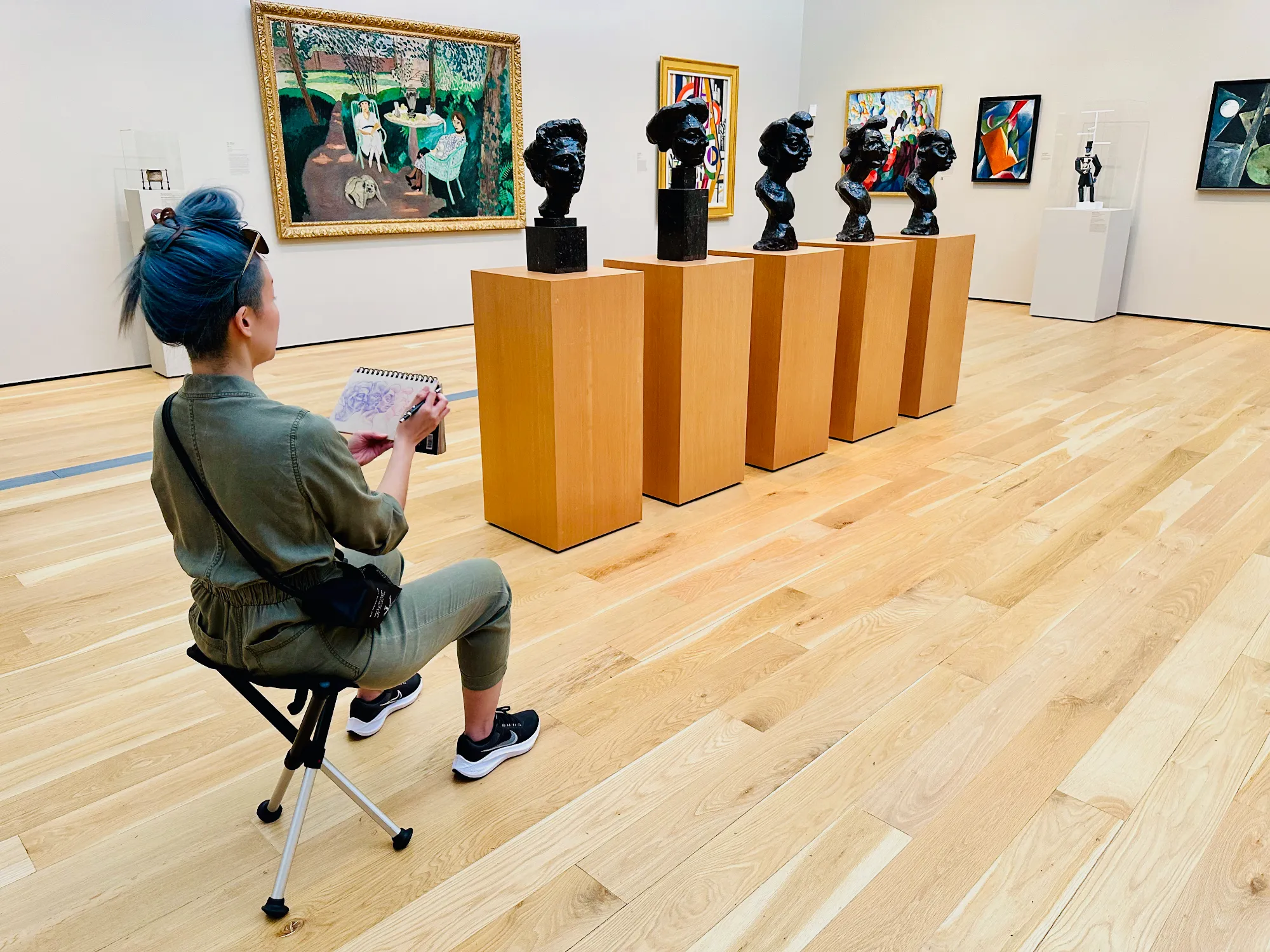 Jiwon Lee sitting in art gallery drawing Rodin head statues